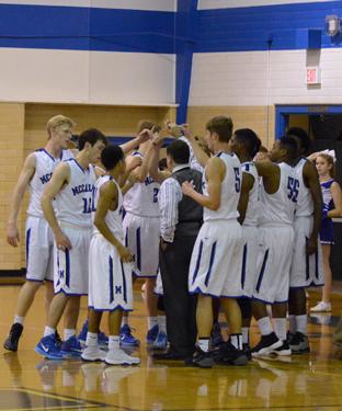 The basketball team huddles at its game against Eastside Memorial Tuesday night. The team won 97-46. Photo by Nick Robertson.