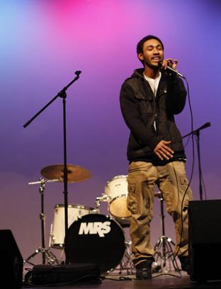 Senior Bomani Barton sings at the Battle of the Bands. The show was a competition between student bands as a fundraiser for the classical guitar program. Photo by Aiden Foster.