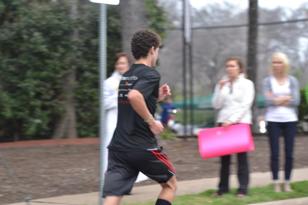 Alonso Fernandez runs past spectators in the Austin Marathon Feb. 15. "People think you’re crazy to do a marathon, but it’s not such a crazy thing," he said. "There’s a lot of good life lessons that you learn.”