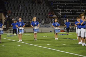 Senior Audrey Holden (center) marches snare at the Taco Shack halftime show.