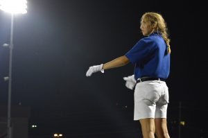 Hannah Wright, a Senior drum major, conducts the band during the Taco Shack halftime show.