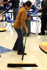 Custodian Maria Mendoza sweeps the cafeteria at the end of lunch.