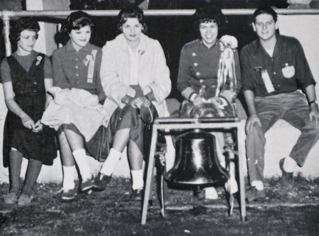 "Caesar had his Brutus, Napoleon his Waterloo, and Travis -- the McCallum game," reads the caption in the 1962 Knight. "The victory bell, purchased by the publications by the publications departments of Travis and McCallum, is guarded by editors from both schools: Judy Calvert, Janet Barkley, and Carolyn Barkley of Travis, and Gwen Chancellor and Bill Towery of McCallum." Photo from the 1962 Knight.