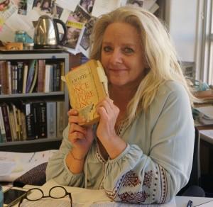 Mrs. Adamson holds her copy of her favorite book. Photo by Madison Olsen.