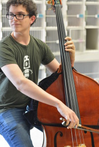 Junior Pablo Kennedy practices a solo piece during Mr. Pringle's fourth-period bass class. Accepted into the National Youth Orchestra, he plans to pursue a career in orchestral bass following his graduation next year. Photo by Julia Robertson. 