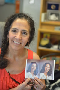 Lucia Facundo, who came to Mac in 1977, hold up her staff photo from the 1982-1983 school year. Photo by Dave Winter.