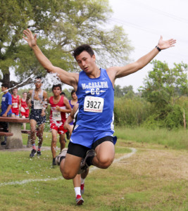 Seeking a little excitement during a race, senior Henry Selis goes airborne as he is hit by a cooling water spray at the AISD Cross Country Invitational on Sept. 2. This was Selis’ first race on the team. “It was hot [that morning],” Selis said. “However, the water splashed on me was a little cold.” Photo by Madison Olsen.