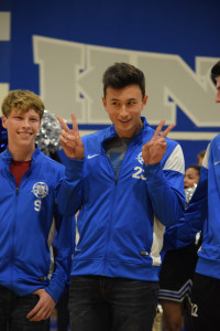 At the spring pep rally on Feb. 3, Cameron Knetig (‘17) looks on as Henry Selis (‘17) flashes peace signs while being introduced to the pep rally crowd. “I had to work hard to play soccer,” Selis said. “My freshman year, I wasn’t be able to make JV.,” Selis said. “I spent the next year practicing and ended up spending sophomore year on JV in a cast all season. It wasn’t till my junior year that I was able to play high school soccer. After years of hard work, I made varsity senior year.” Photo by Dave Winter. 