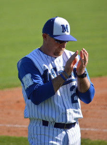 Coach Houston encourages a batter during McCallum's victory over LBJ in March. Photo by Dave Winter.