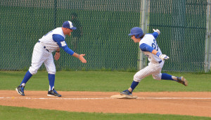 Coach Huston congratulates Quentin Reed as he circles the bases after homering in last year's district-clinching victory over Cedar Creek at NW Pony Field. Photo by Dave Winter.